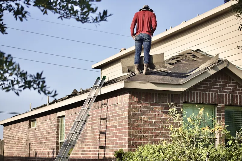 Professional roofer working on a residential roof in Perkins Corner